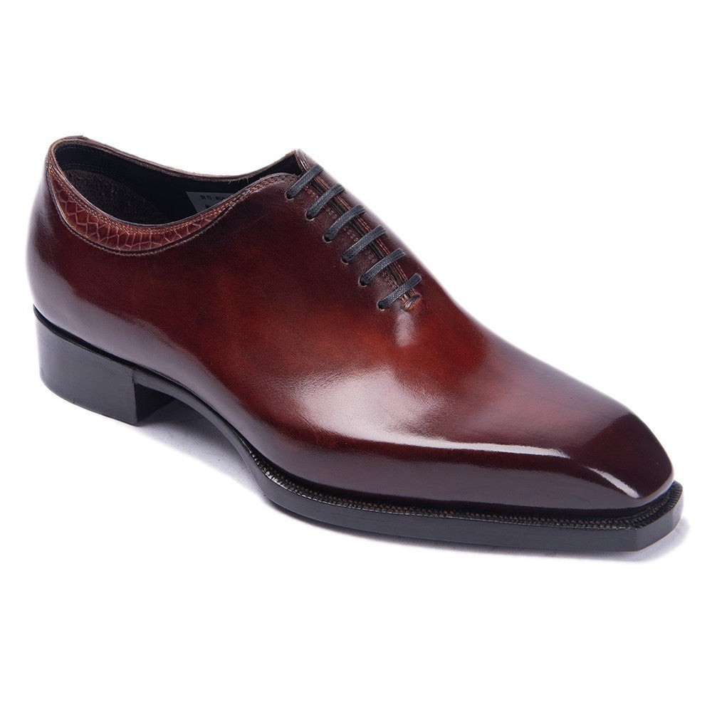 Brown leather dress shoe on a white background