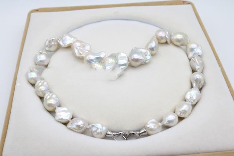 Pearl necklace on a heart-shaped pillow in a box