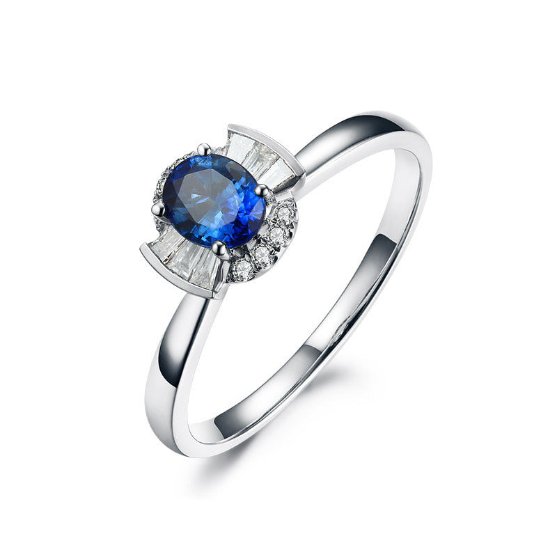 Silver ring with a blue gemstone on a white background