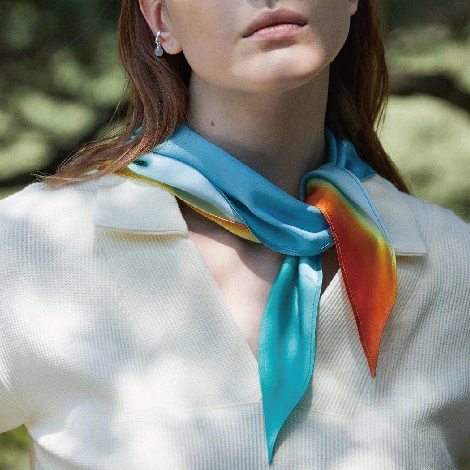 Woman wearing a colorful scarf with a blurred natural background