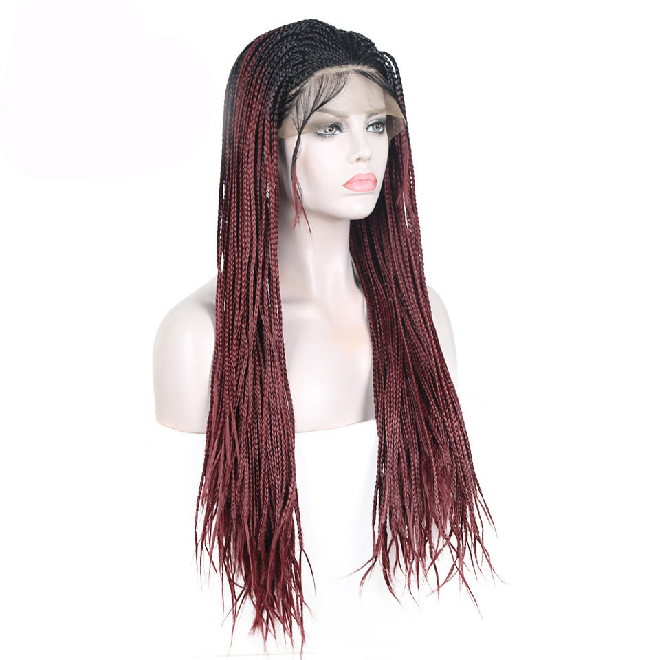 Mannequin head with a wig featuring black and red braided hair on a white background