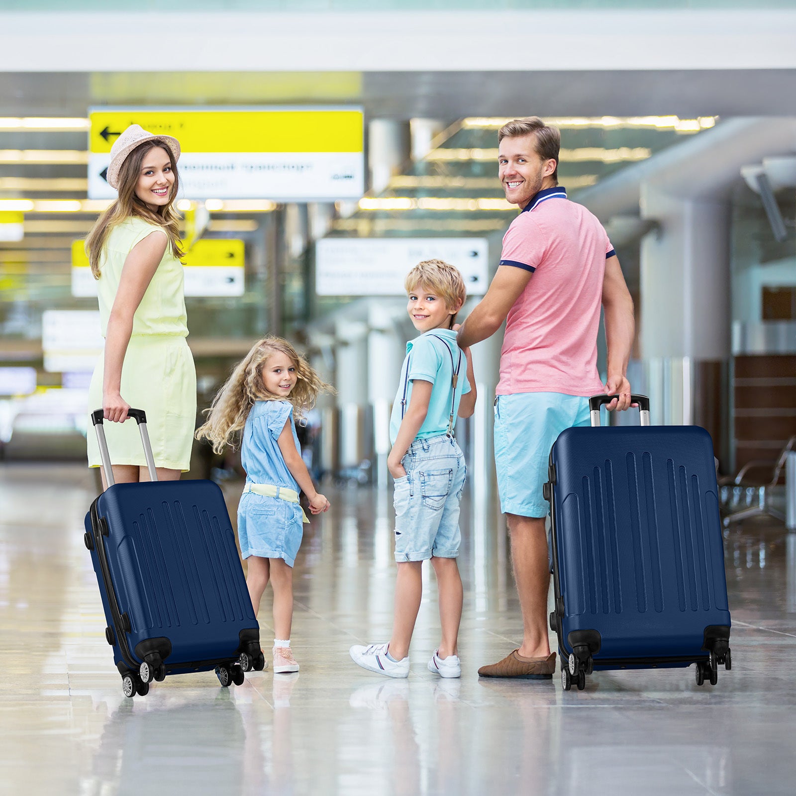 Family of four with luggage at an airport