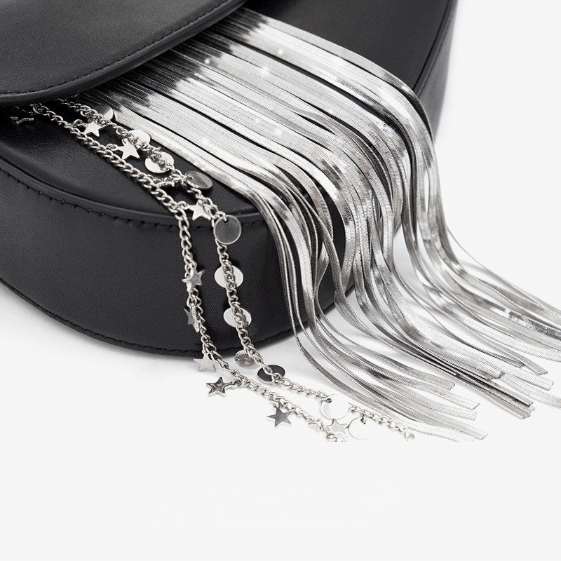 Black handbag with silver tassels and star-shaped charms on a white background