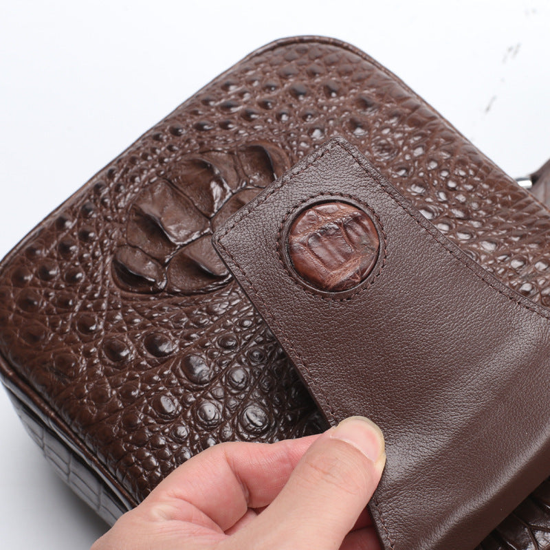 Brown textured leather wallet with a hand holding it on a white background