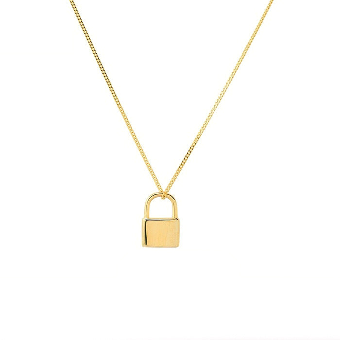 Gold padlock necklace on a white background