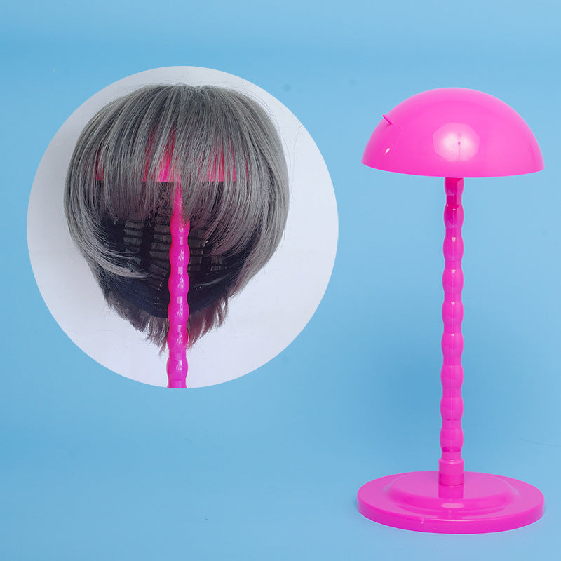 Pink hair styling tool with a close-up inset on a blue background