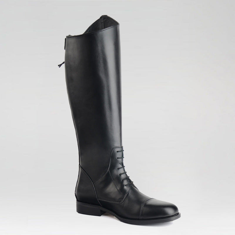 Black leather riding boot on a light gray background