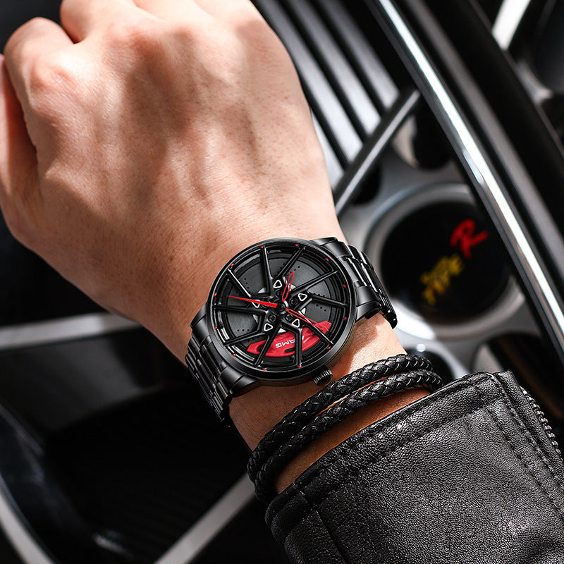 Person wearing a black wristwatch with red accents inside a car.