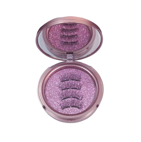 Open makeup compact with pink glittery eyeshadow on a white background