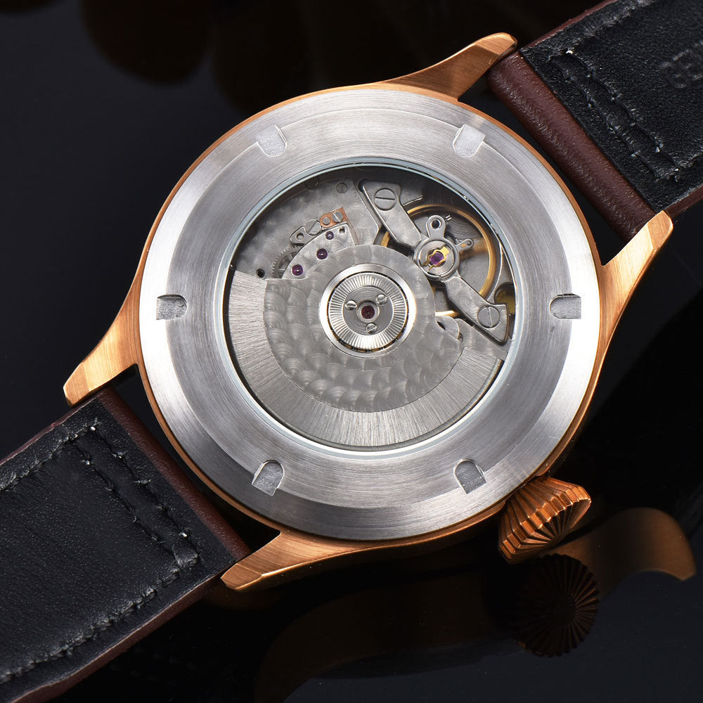 Watch with black leather strap and metallic case on a dark background