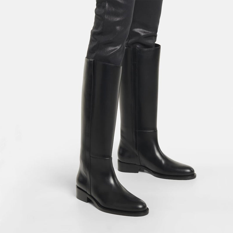 Black knee-high boots on a white background