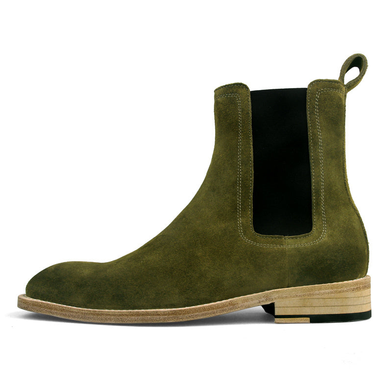 Green suede Chelsea boot on a white background