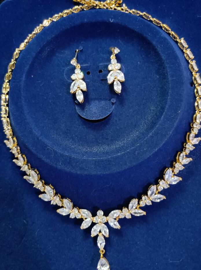 Jewelry set with necklace and earrings on a blue background