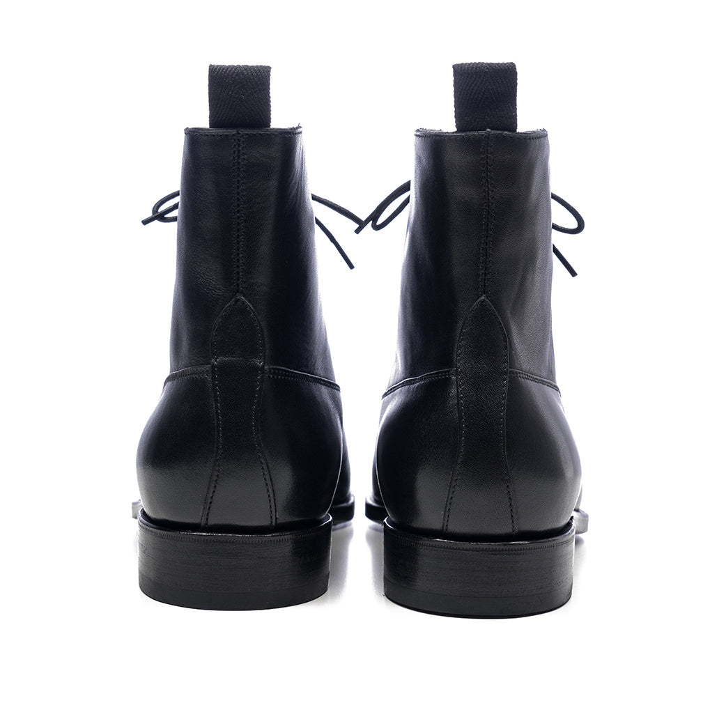 Black leather boots on a white background