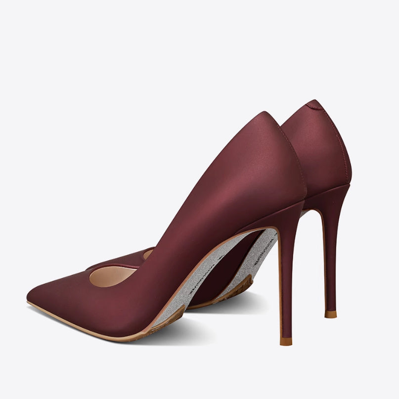 Pair of maroon high-heeled shoes on a white background