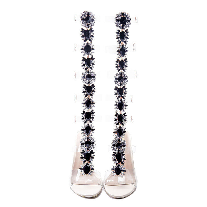 Long earrings with black and clear gemstones on a white background