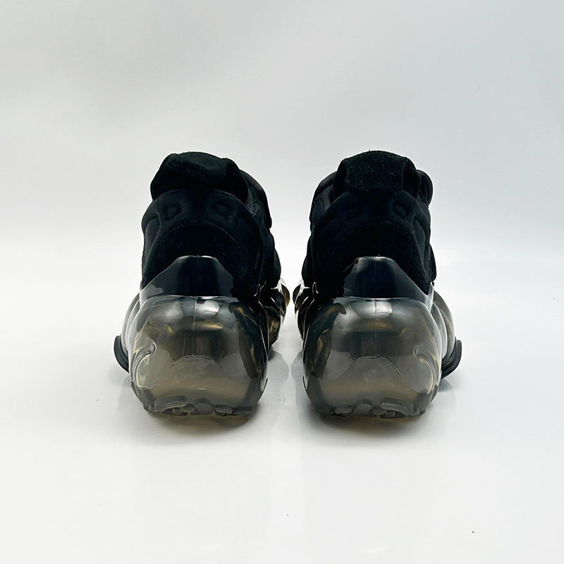 Black high-top sneakers with transparent sole on a white background