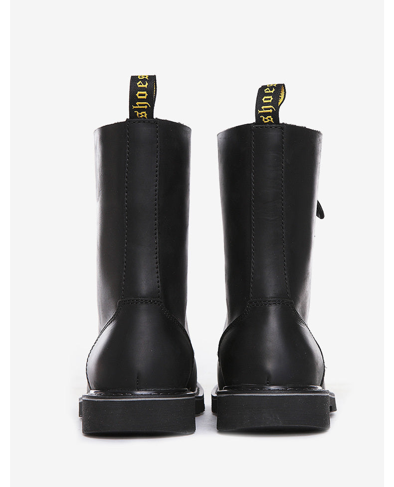 Pair of black boots with visible brand name on a white background