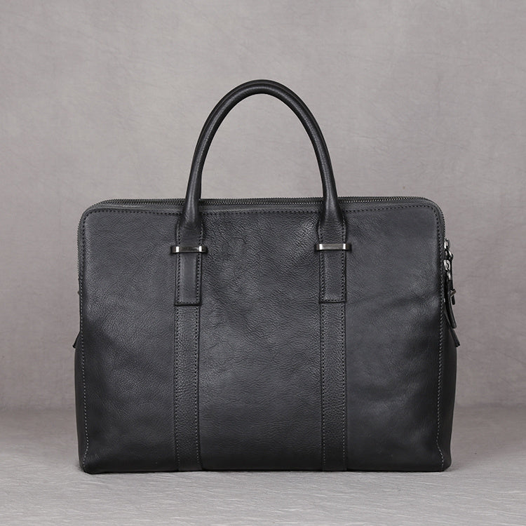 Black leather briefcase on a gray background