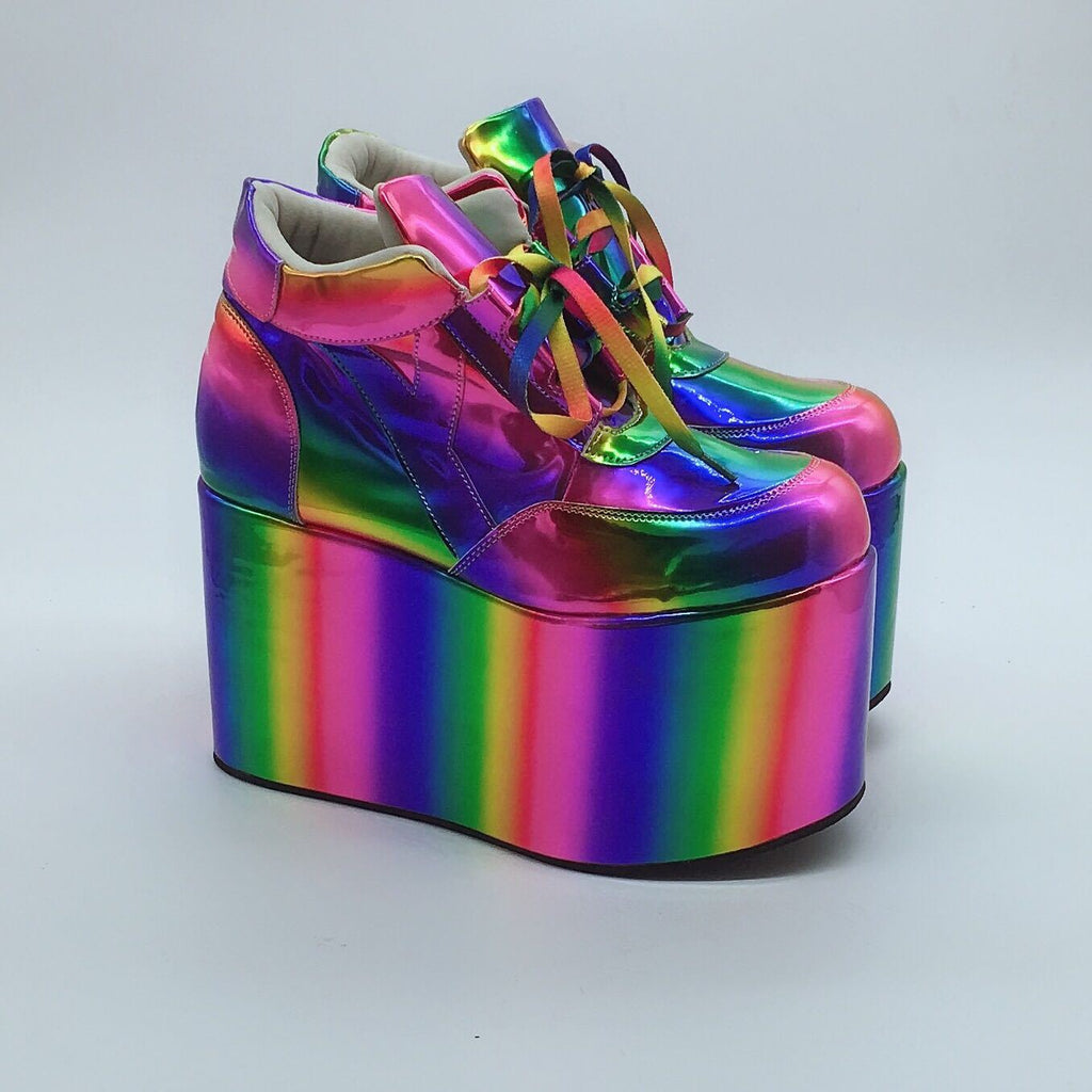 Multicolored platform shoes with rainbow laces on a light gray background