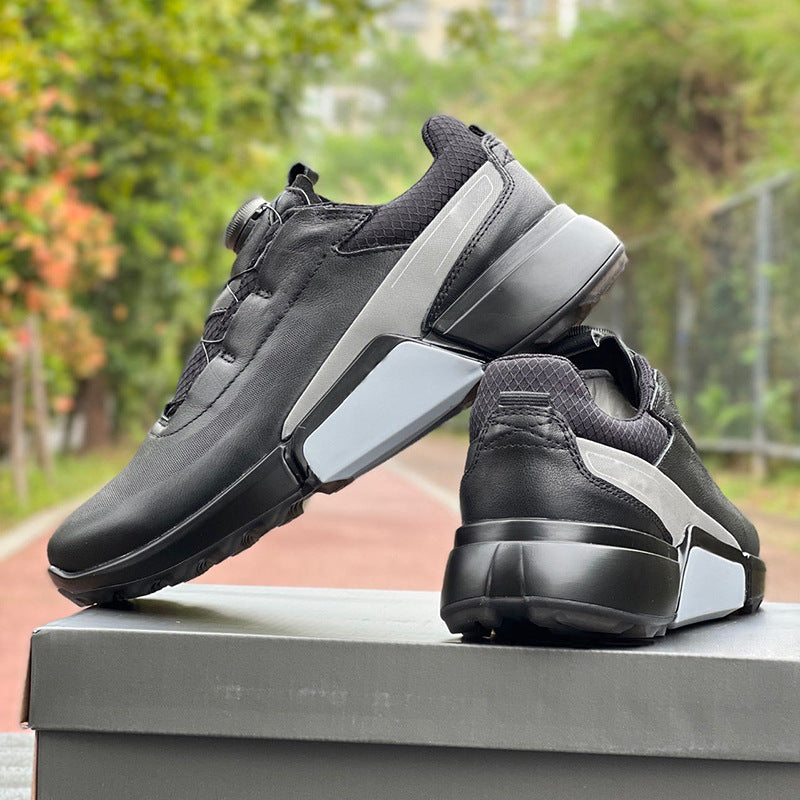 Black and gray athletic shoes on a box with a blurred outdoor background