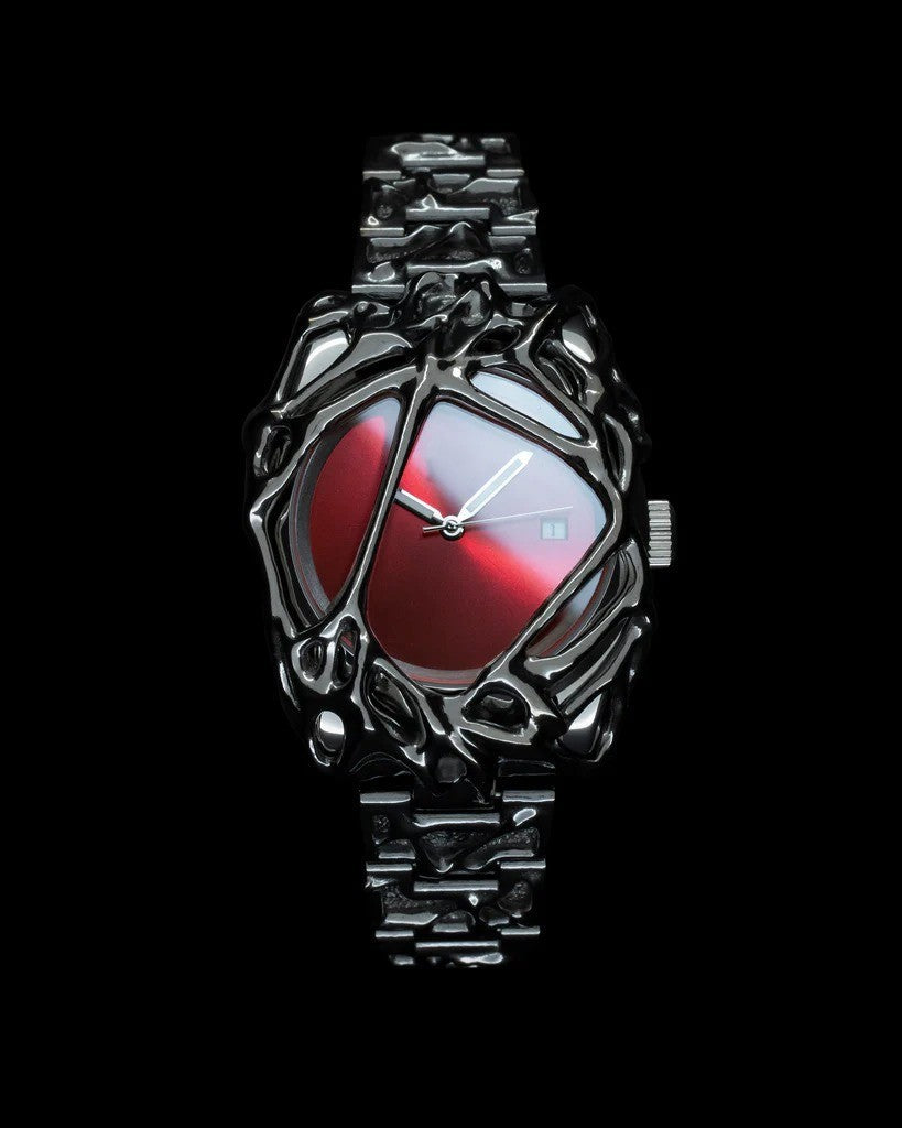 Futuristic wristwatch with red face and metallic design on a black background