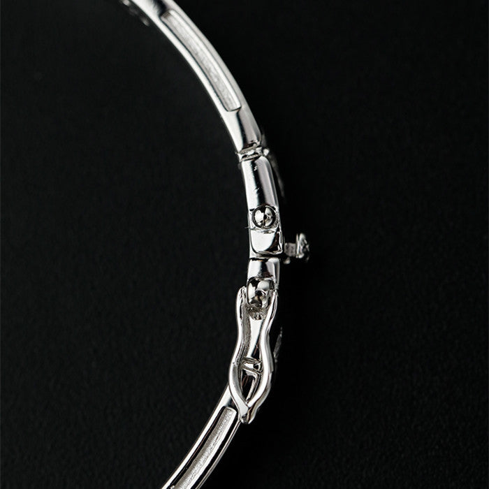 Silver bracelet on a black background