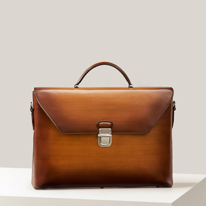 Brown leather briefcase on a light gray background