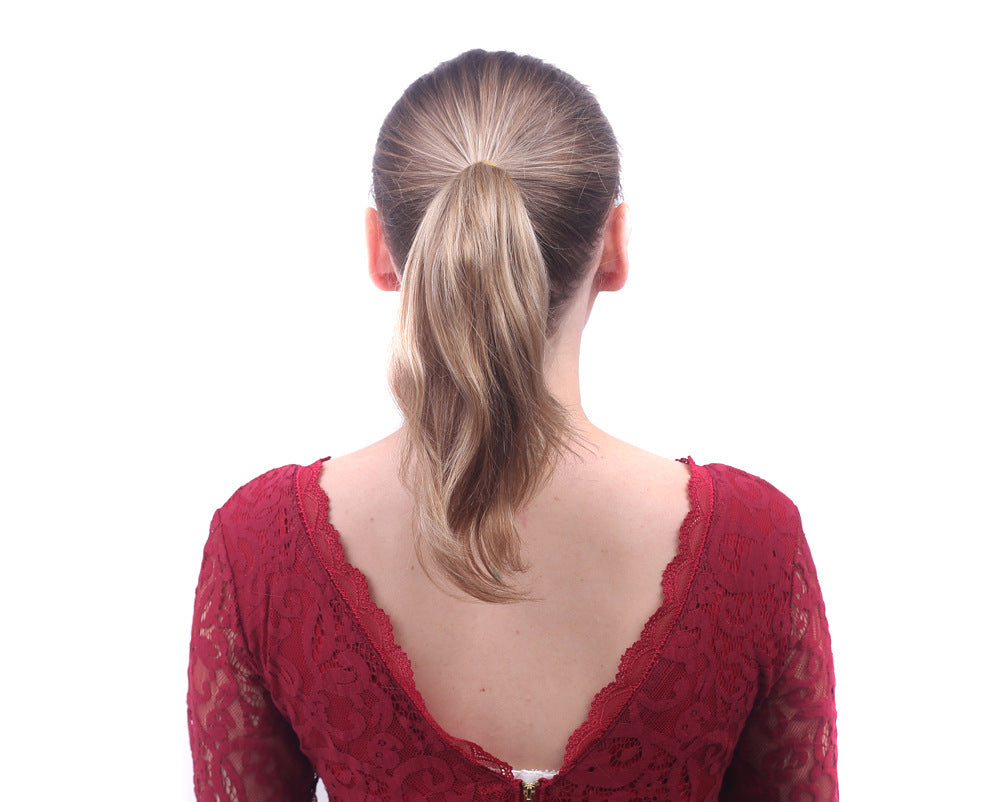 Back view of a person wearing a red lace top on a white background