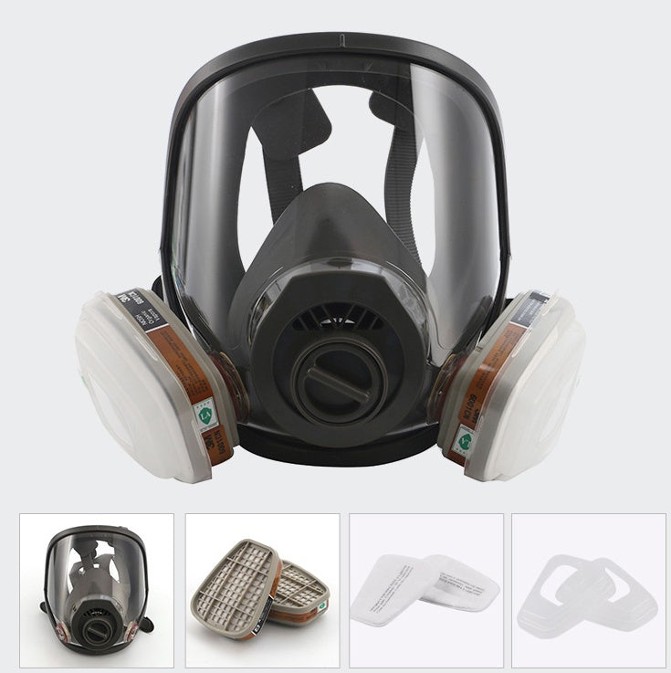 Full-face respirator mask with filter cartridges on a white background