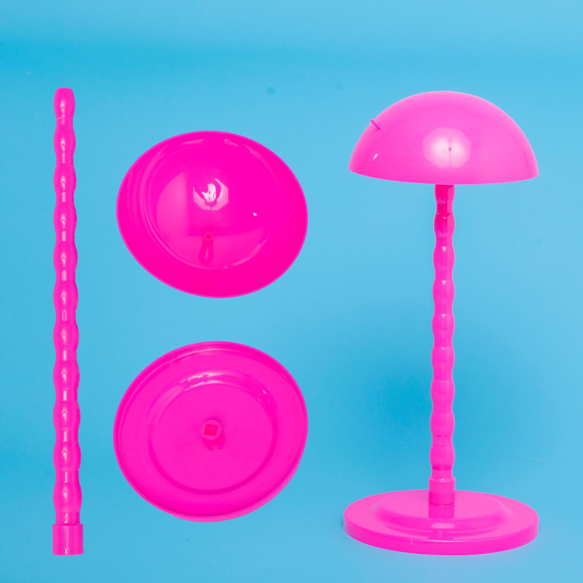 Set of pink plastic toys on a blue background