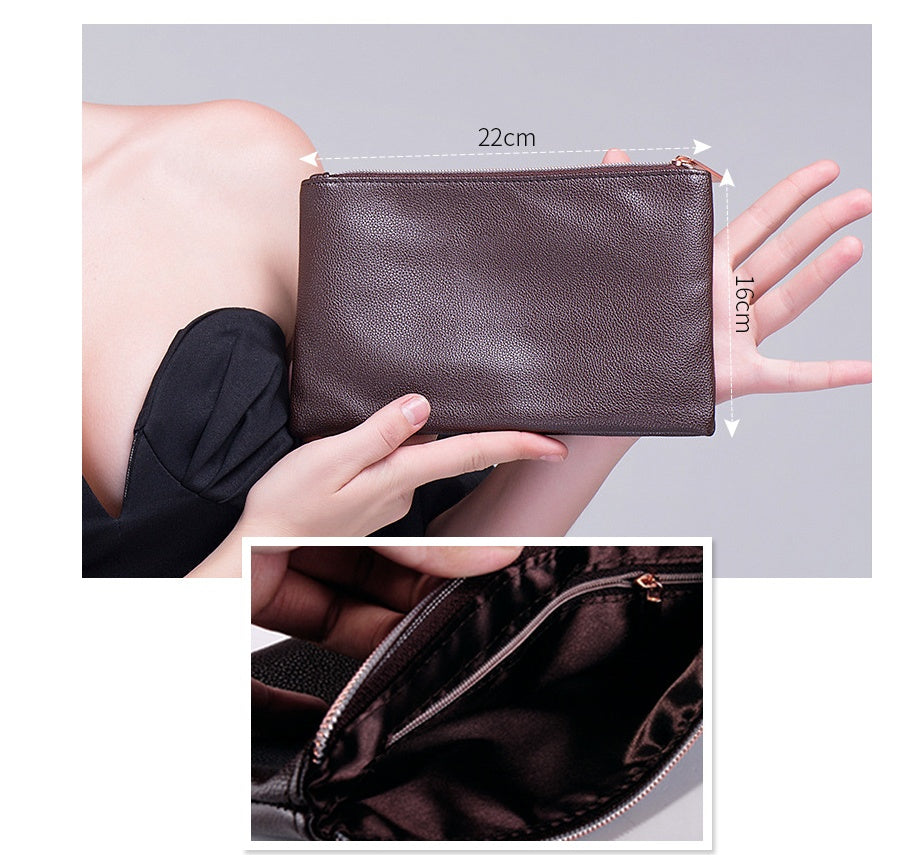 Brown clutch bag held by a person with measurements displayed