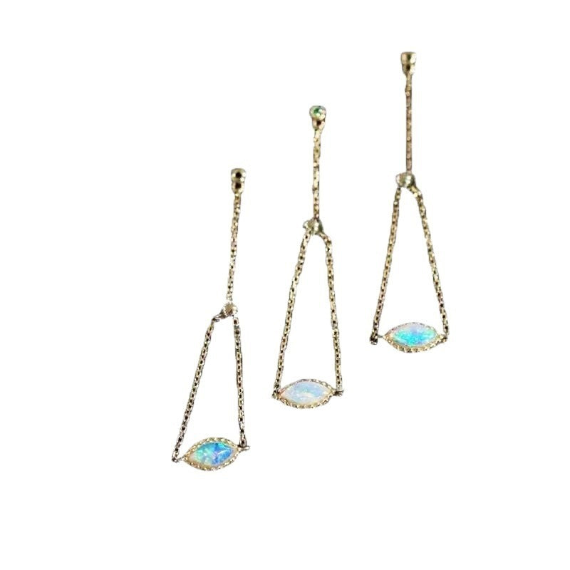 Pair of gold earrings with gemstones on a white background