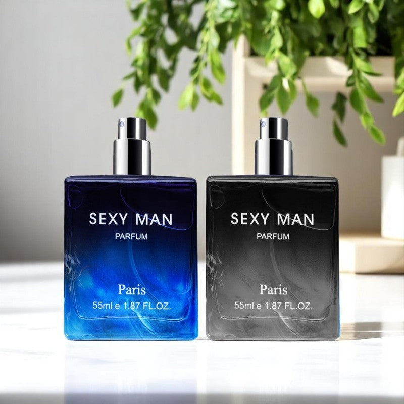 Two bottles of 'Sexy Man Parfum Paris' with a plant in the background.