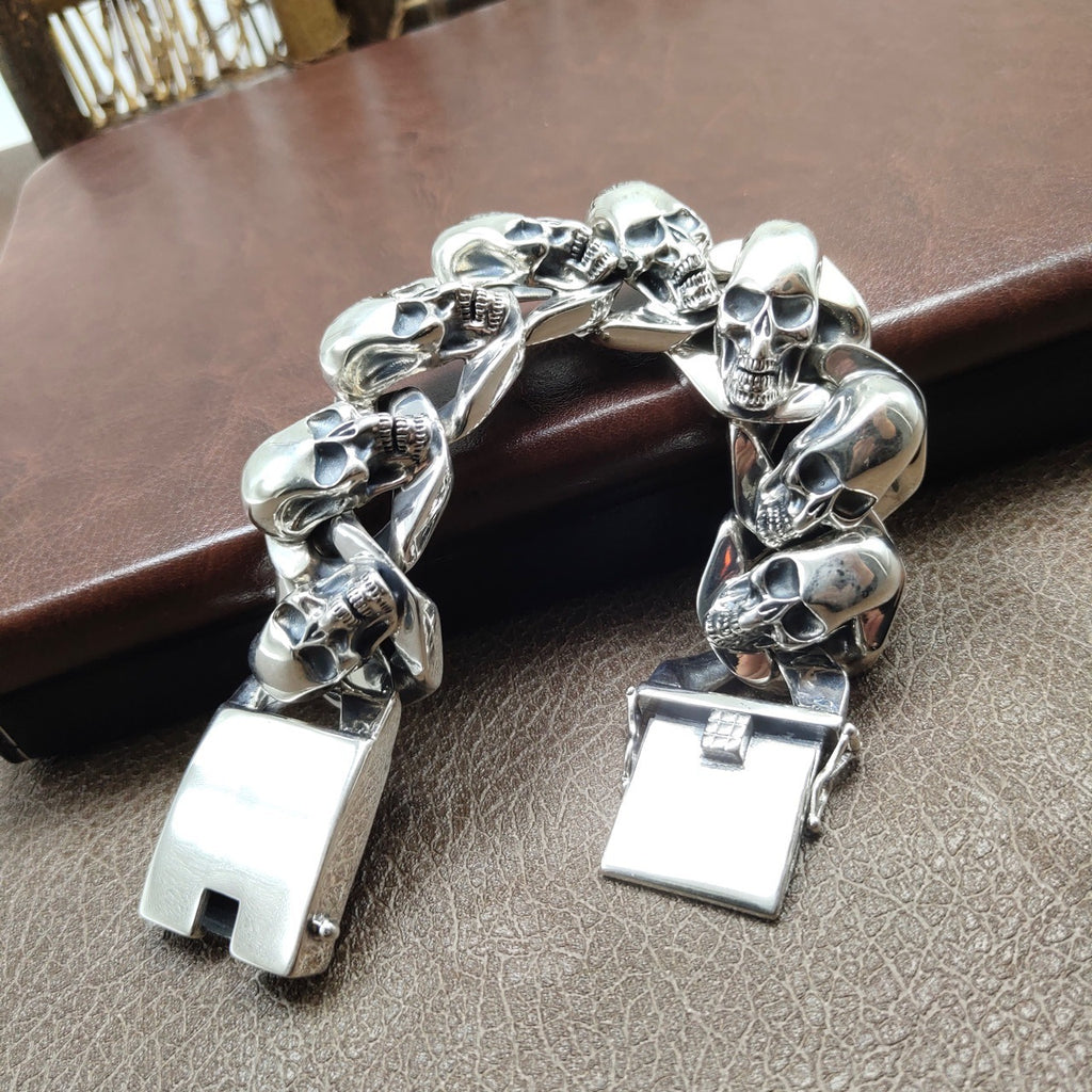 Silver skull bracelet on a textured surface