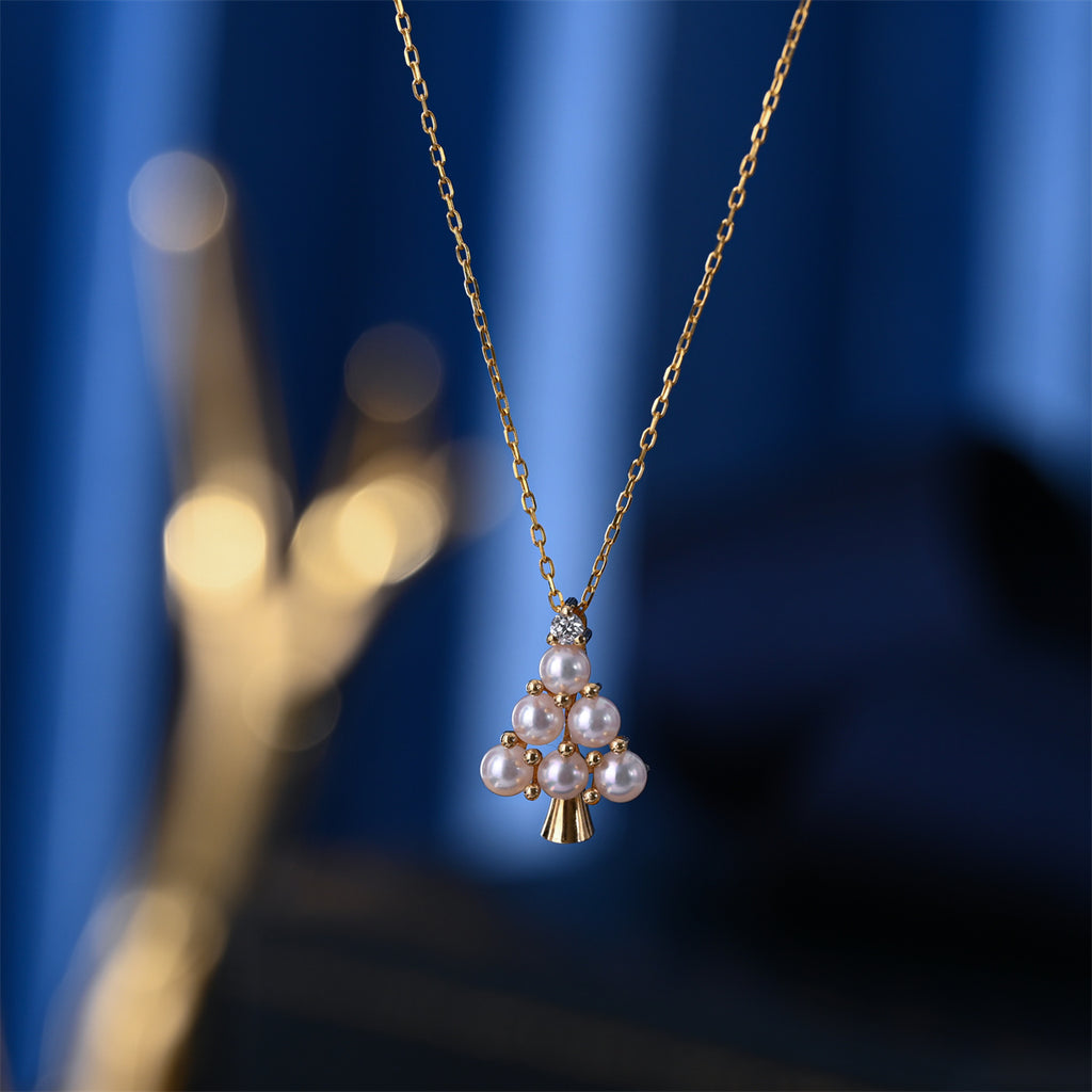 Pearl necklace with gold chain on a blue background