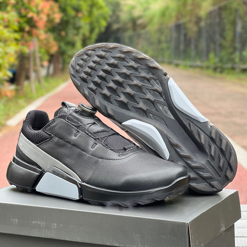Black and gray athletic shoes on a box with a blurred outdoor background