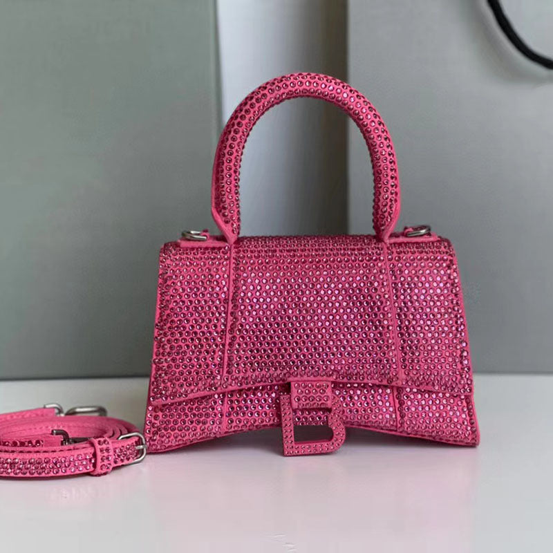 Pink handbag with matching leash on a light surface with a gray background