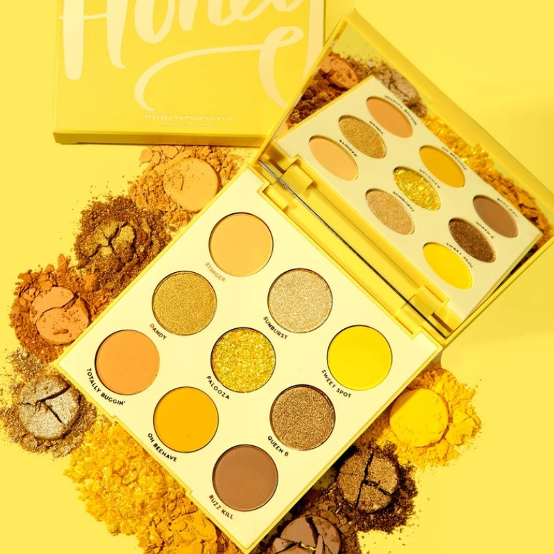 Makeup palette with yellow and brown shades on a yellow background