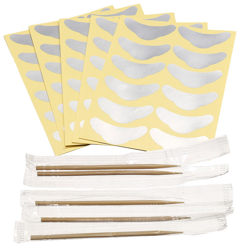 Set of yellow adhesive patches with white shapes on top and white sticks with gold bands below on a white background.