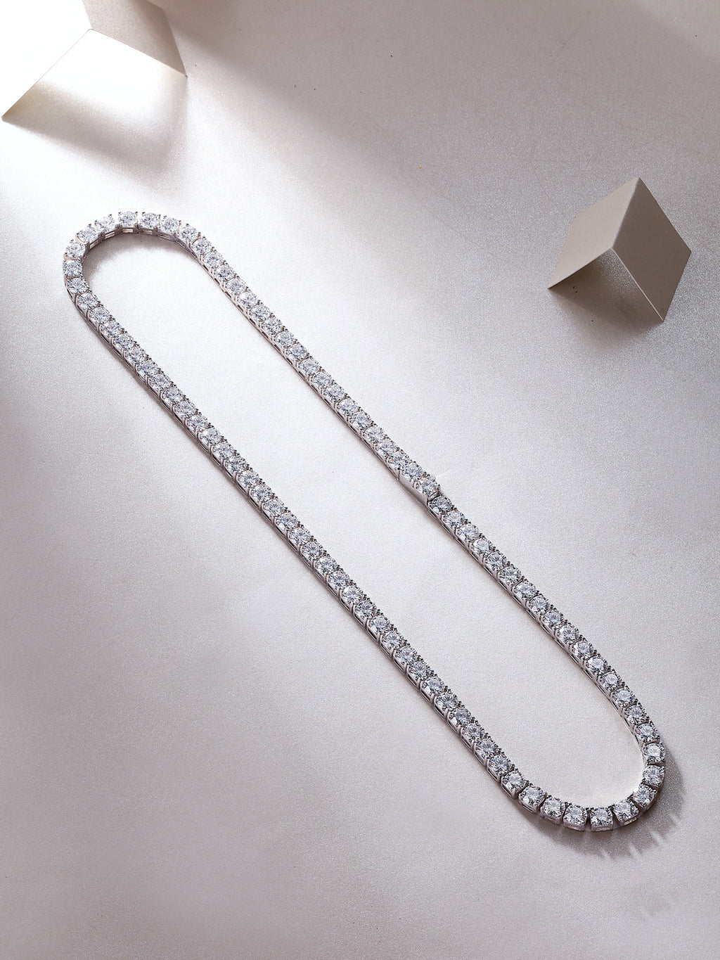 Diamond tennis necklace on a light gray background