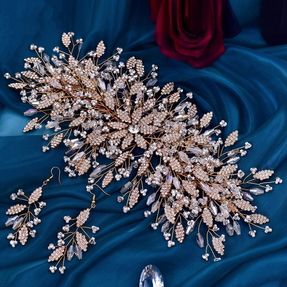 Ornate jewelry set with a hairpiece and earrings on a blue fabric background
