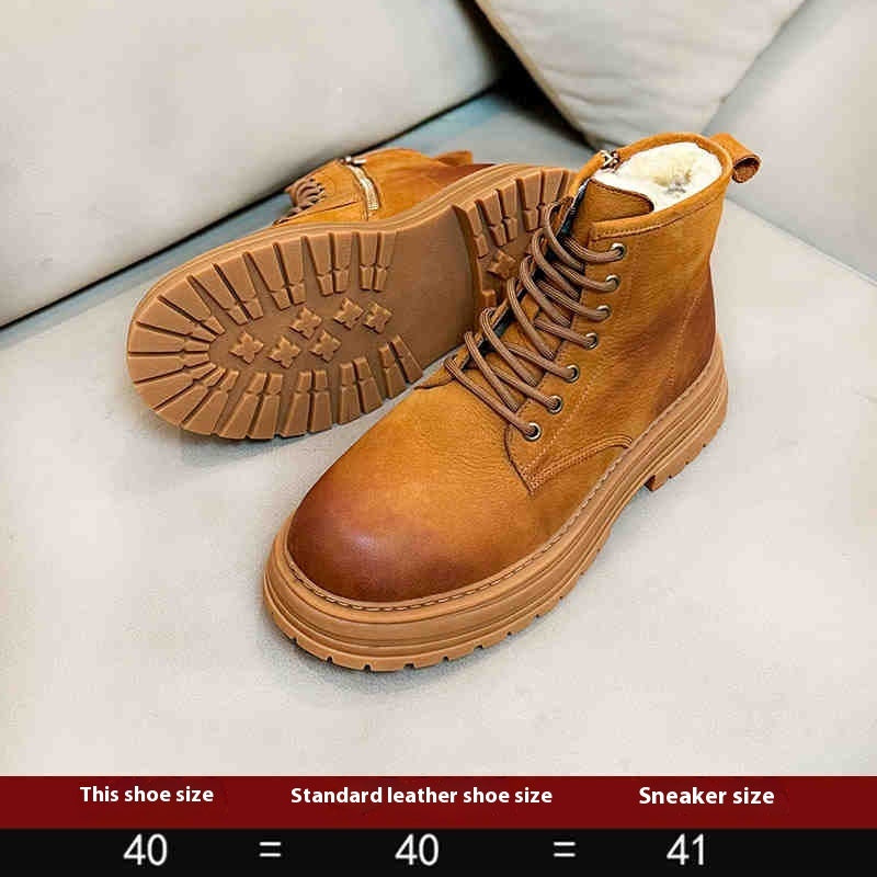 Brown leather boots on a light gray surface with size information at the bottom.