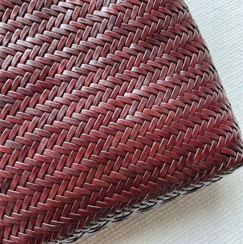 Close-up of a woven red-brown cushion on a white background