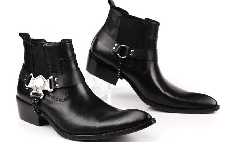 Black leather boots with silver buckles on a white background