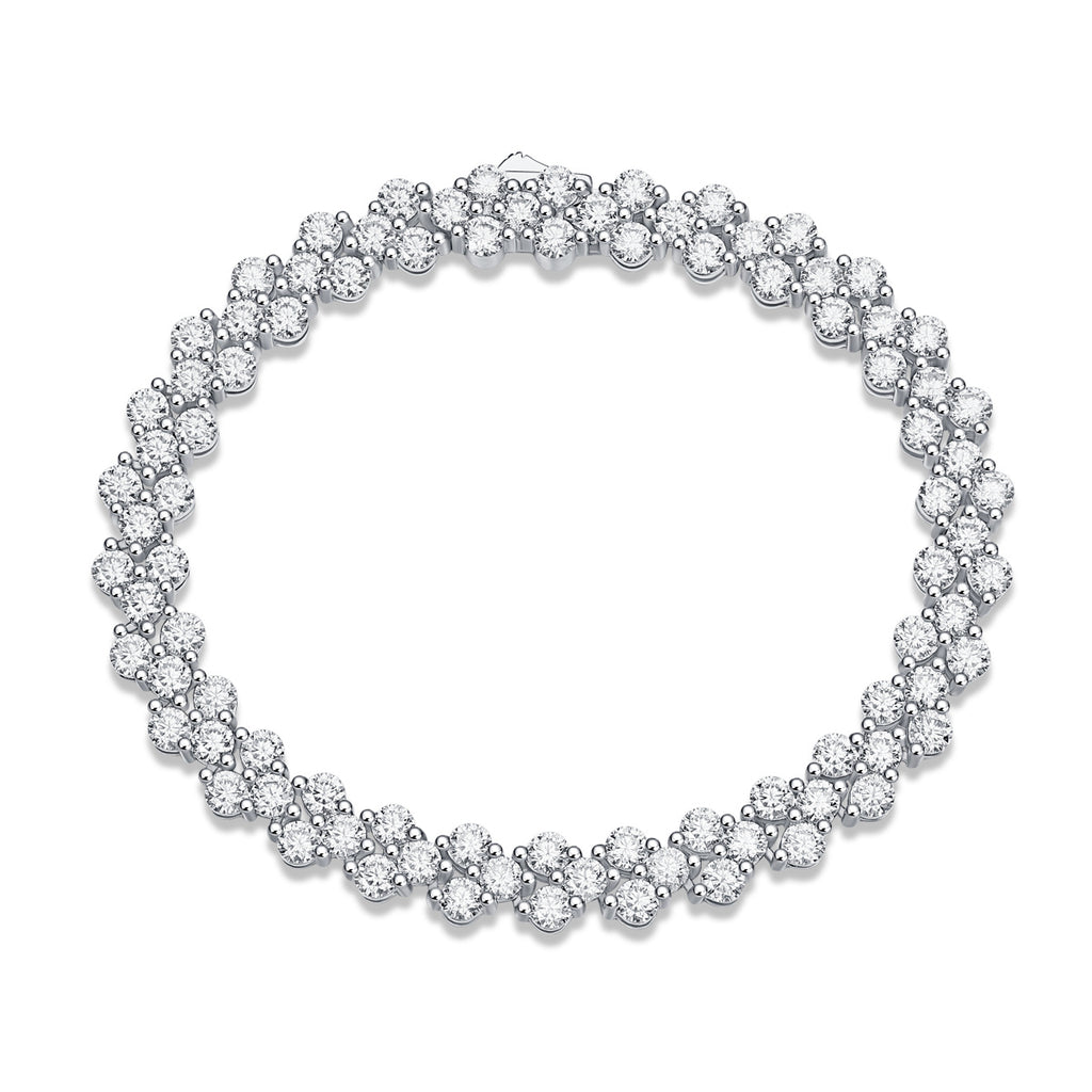 Silver bracelet with clear gemstones on a white background