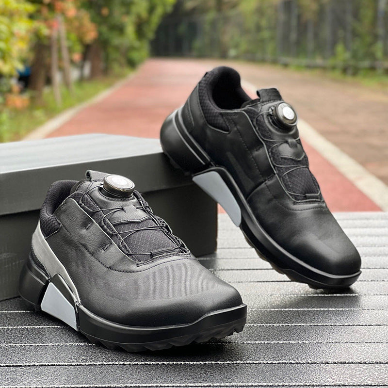 Black athletic shoes with white soles on a wooden surface, blurred greenery in the background