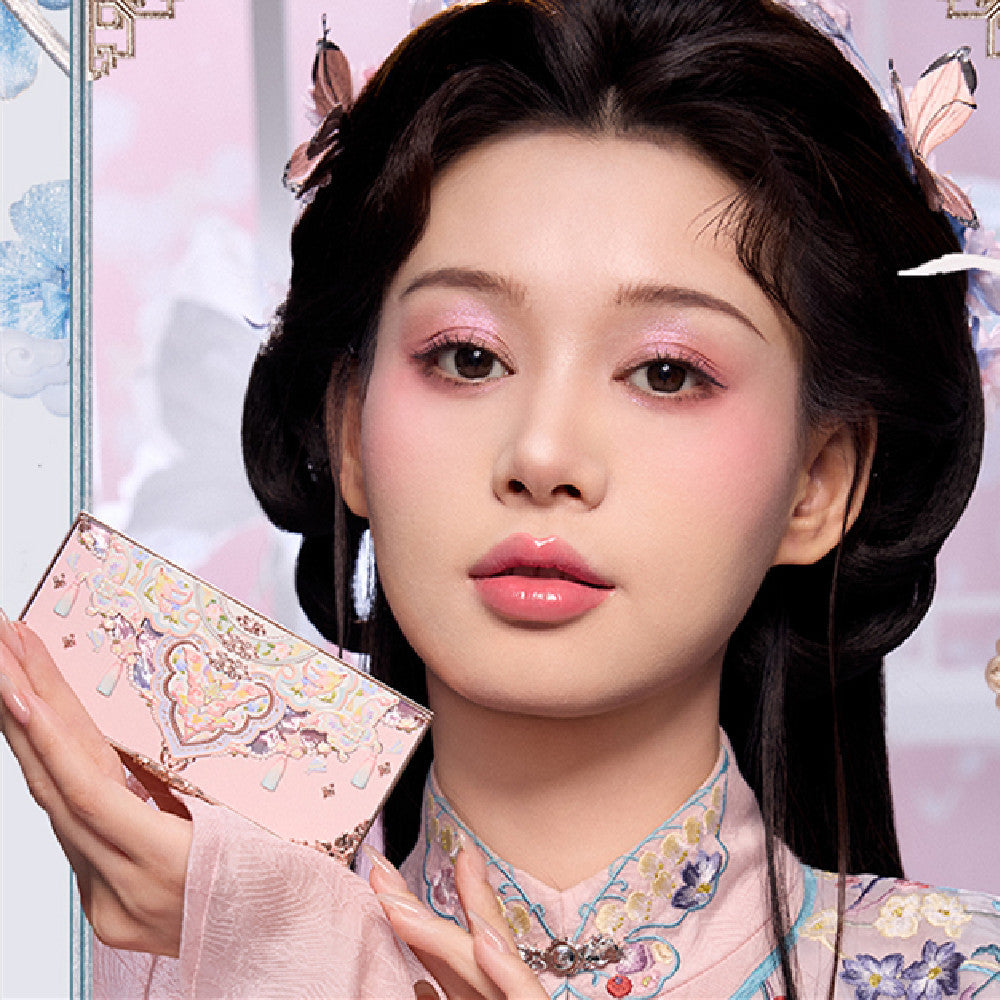 Woman holding a pink makeup palette with decorative elements