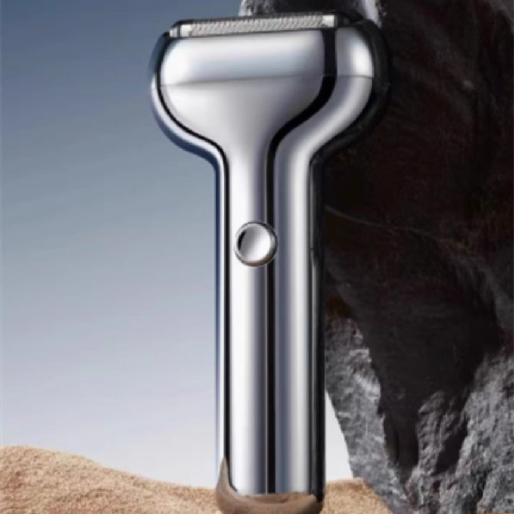 Metallic grooming tool on a textured surface with a neutral background