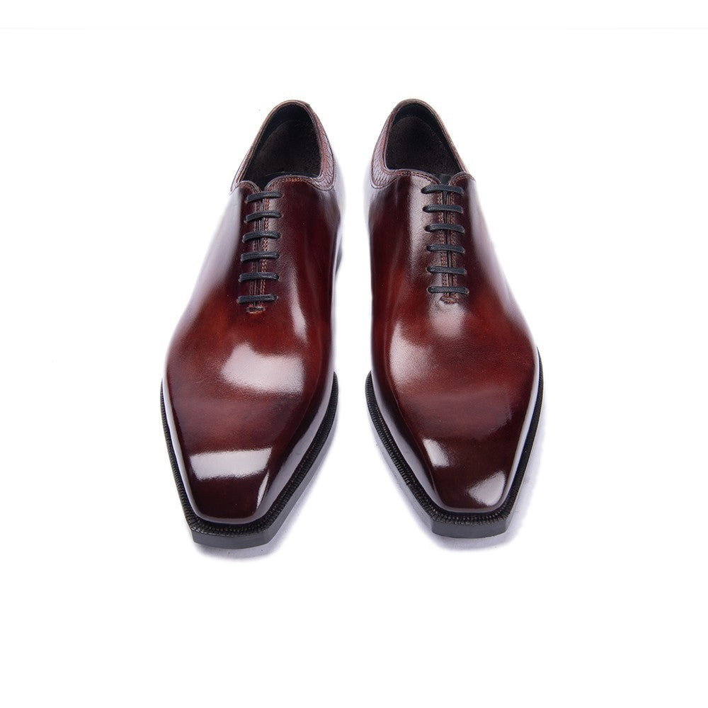 Pair of brown dress shoes on a white background